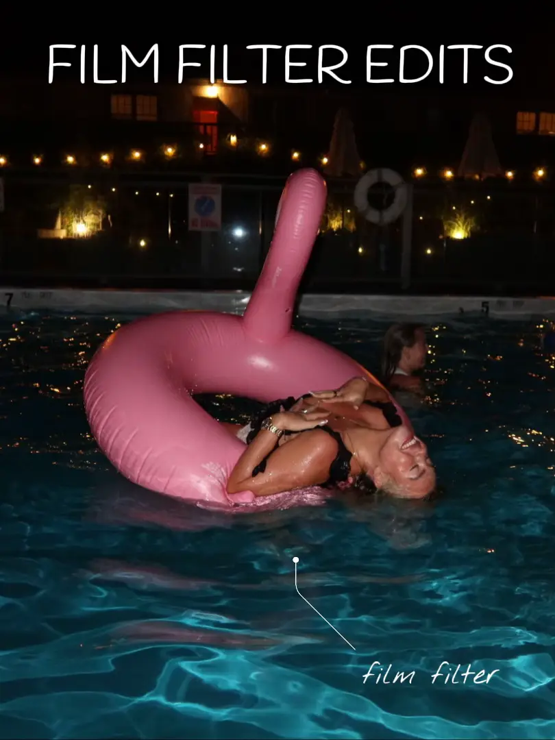  A woman is in a pool with a pink float.
