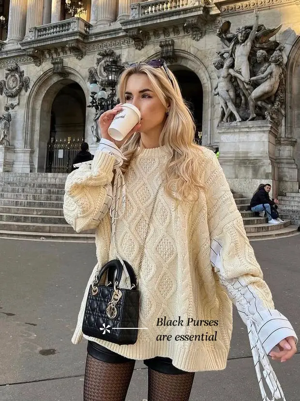  A woman in a brown sweater and black lace up boots is drinking coffee from a cup. She is holding the cup in her hand and appears to be enjoying her beverage.