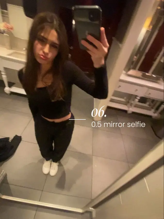  A woman is taking a mirror selfie.