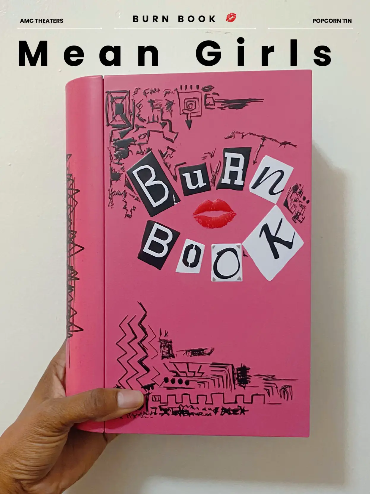  A pink book with the words "Burn Book" on the front.