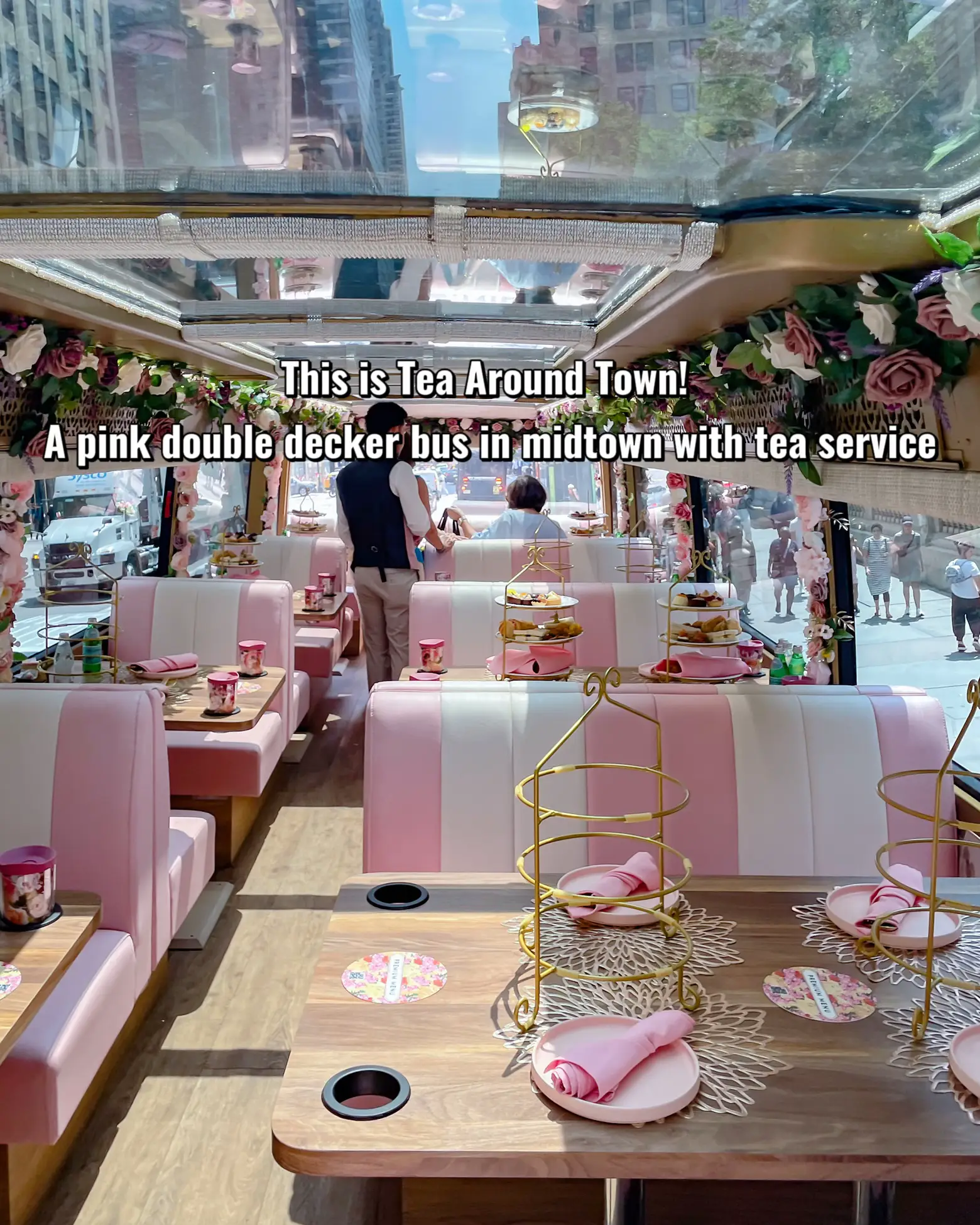  A pink double decker bus in midtown with tea service.
