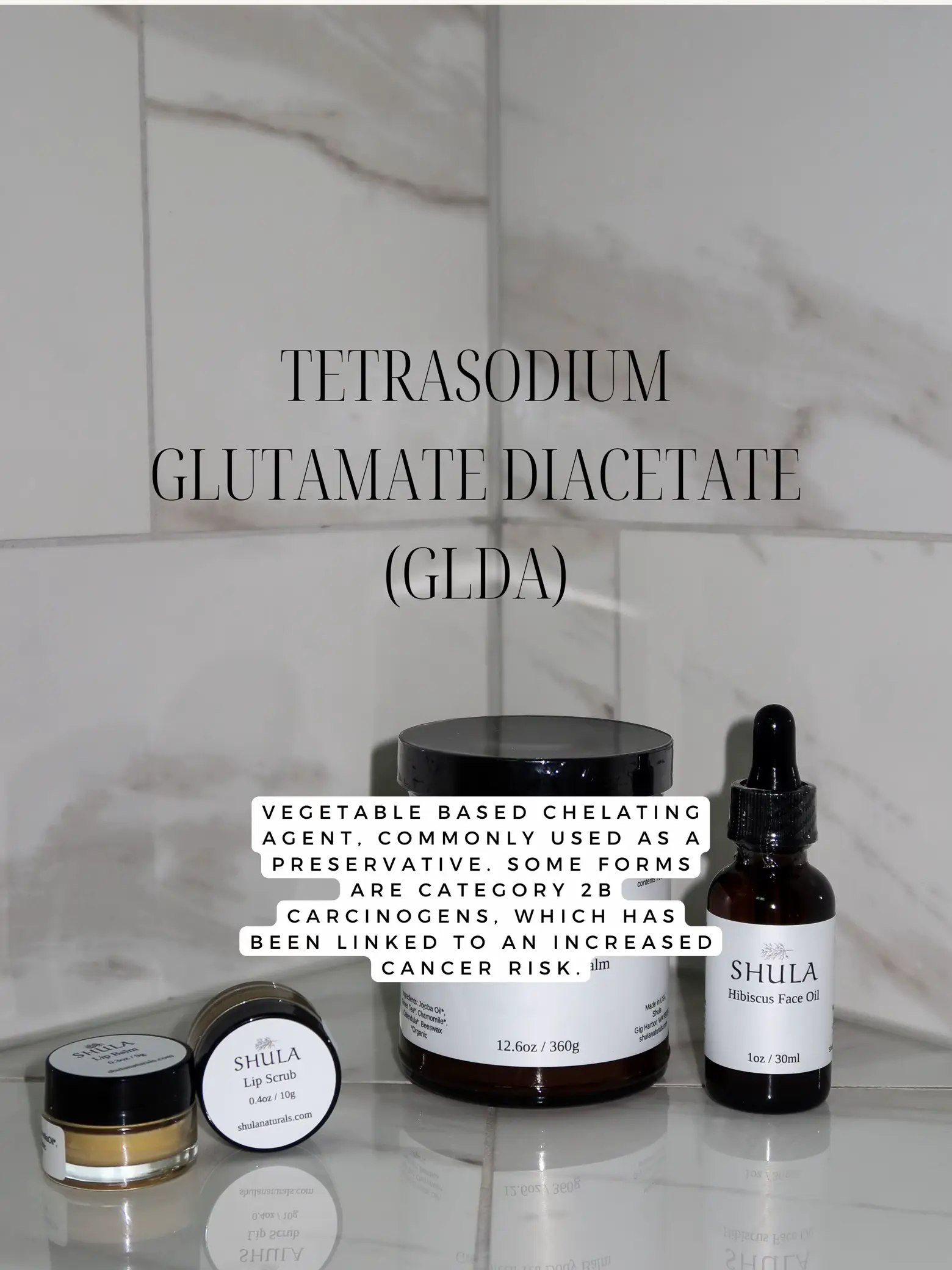 A bottle of Tetrasodium glutamate diacetate (GLDA) is displayed on a counter next to a bottle of Lip Scrub.