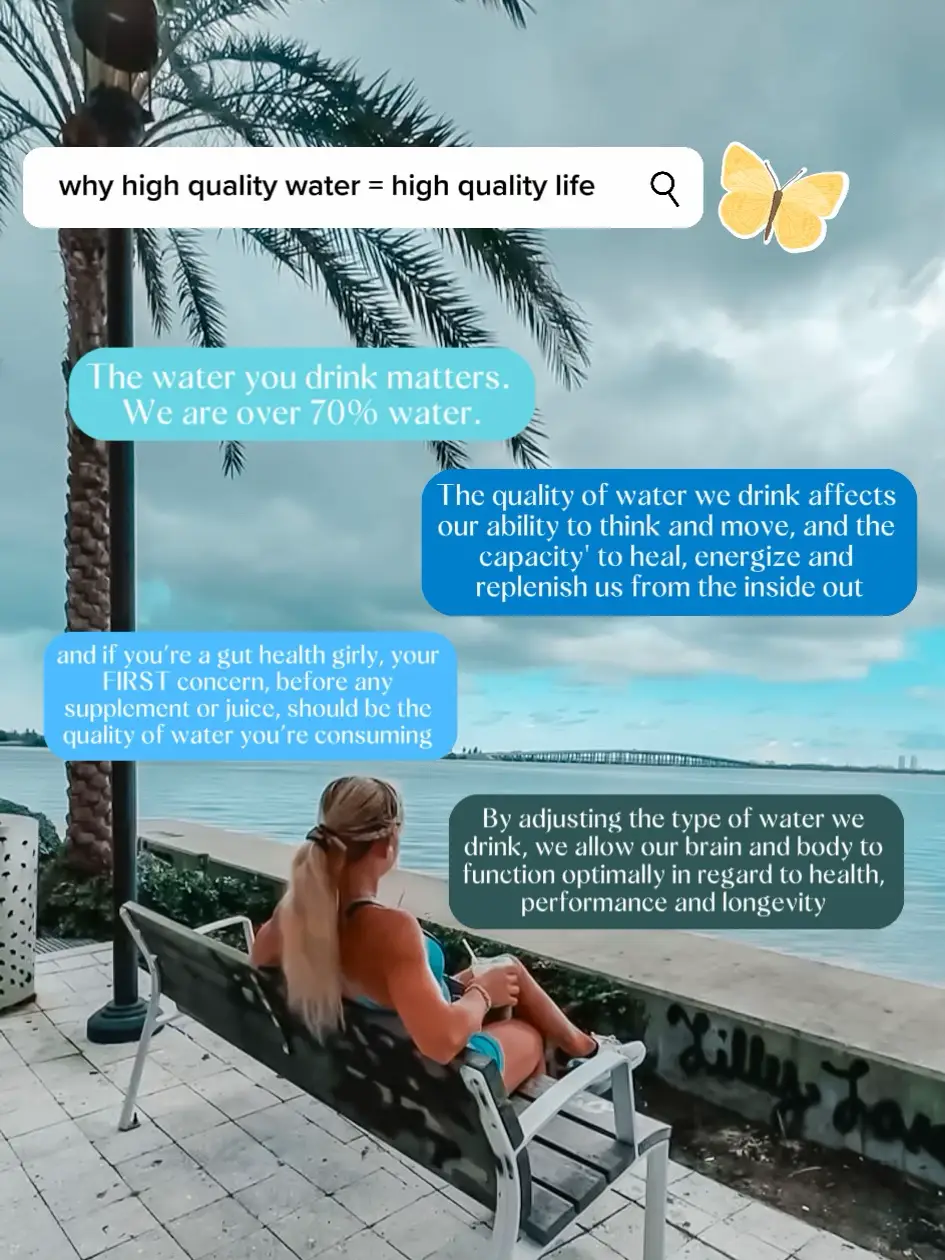  A woman is sitting on a bench near the water, and there is a sign that says "why high quality water = high quality life".