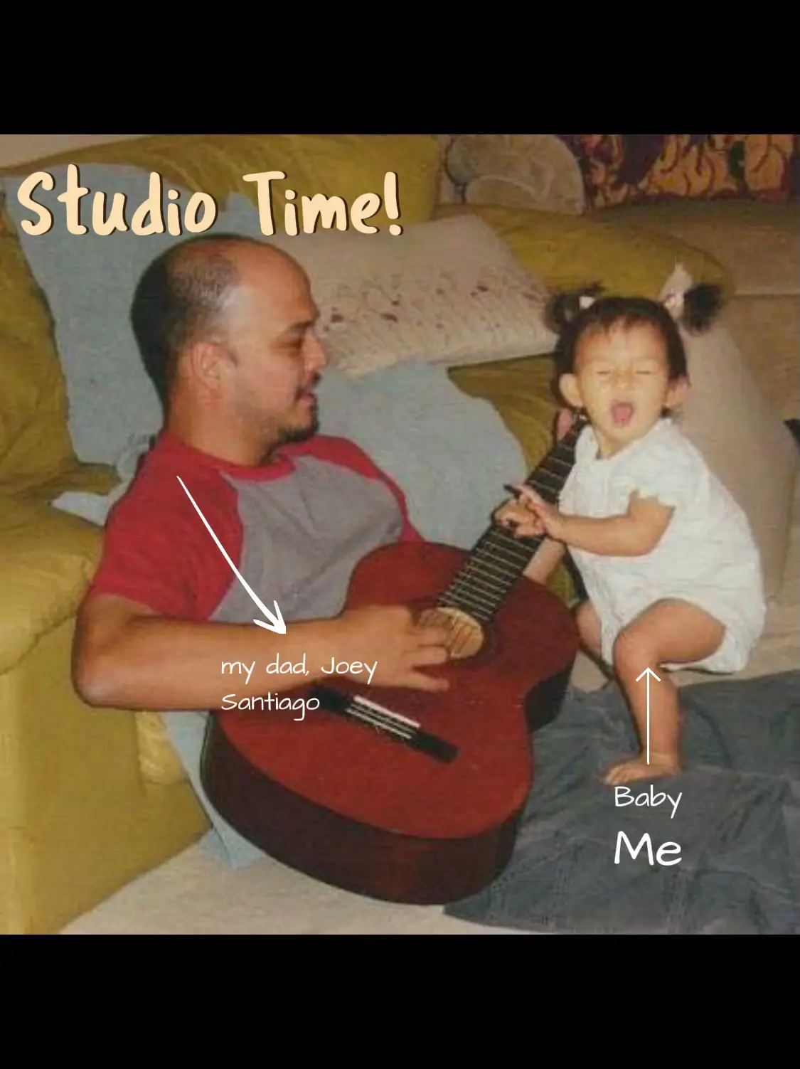  A man is playing a guitar while a baby is standing next to him.