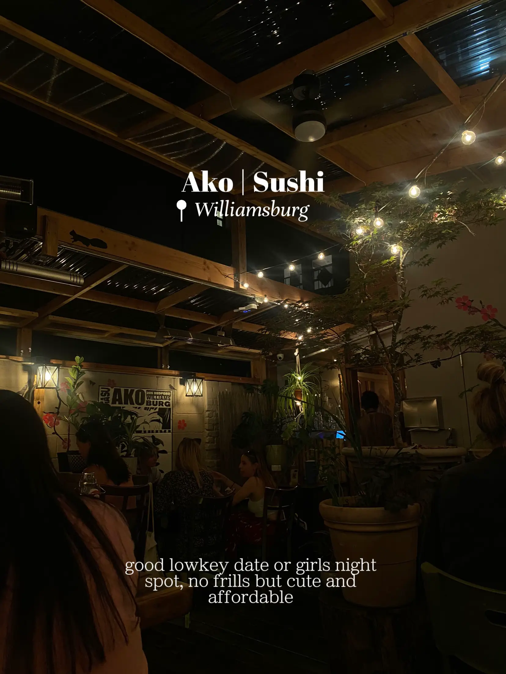  A restaurant with a sushi menu and a woman sitting at a table.