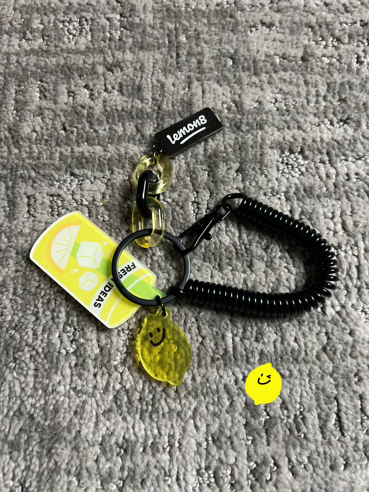  A keychain with a lemon on it and a smiley face.