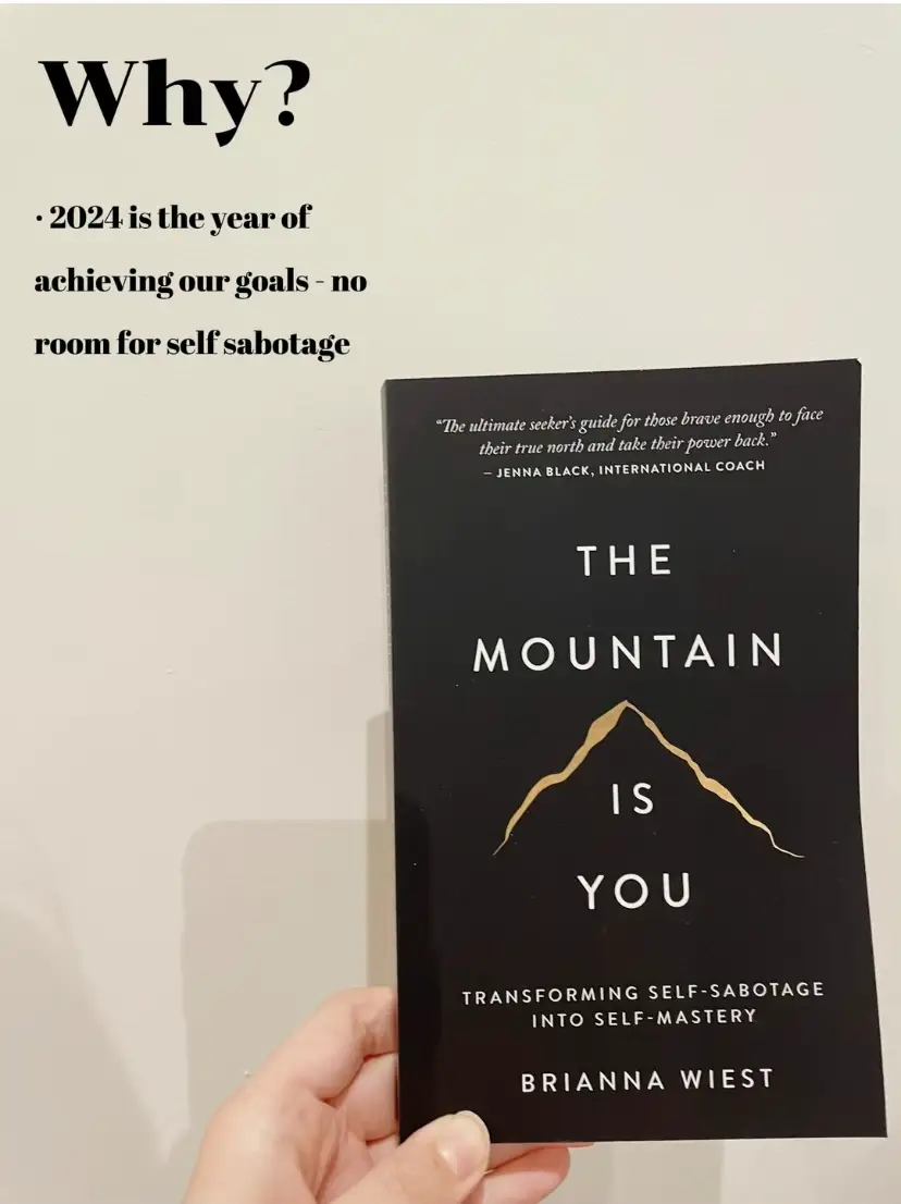  A book titled The Mountain is being held by a person.