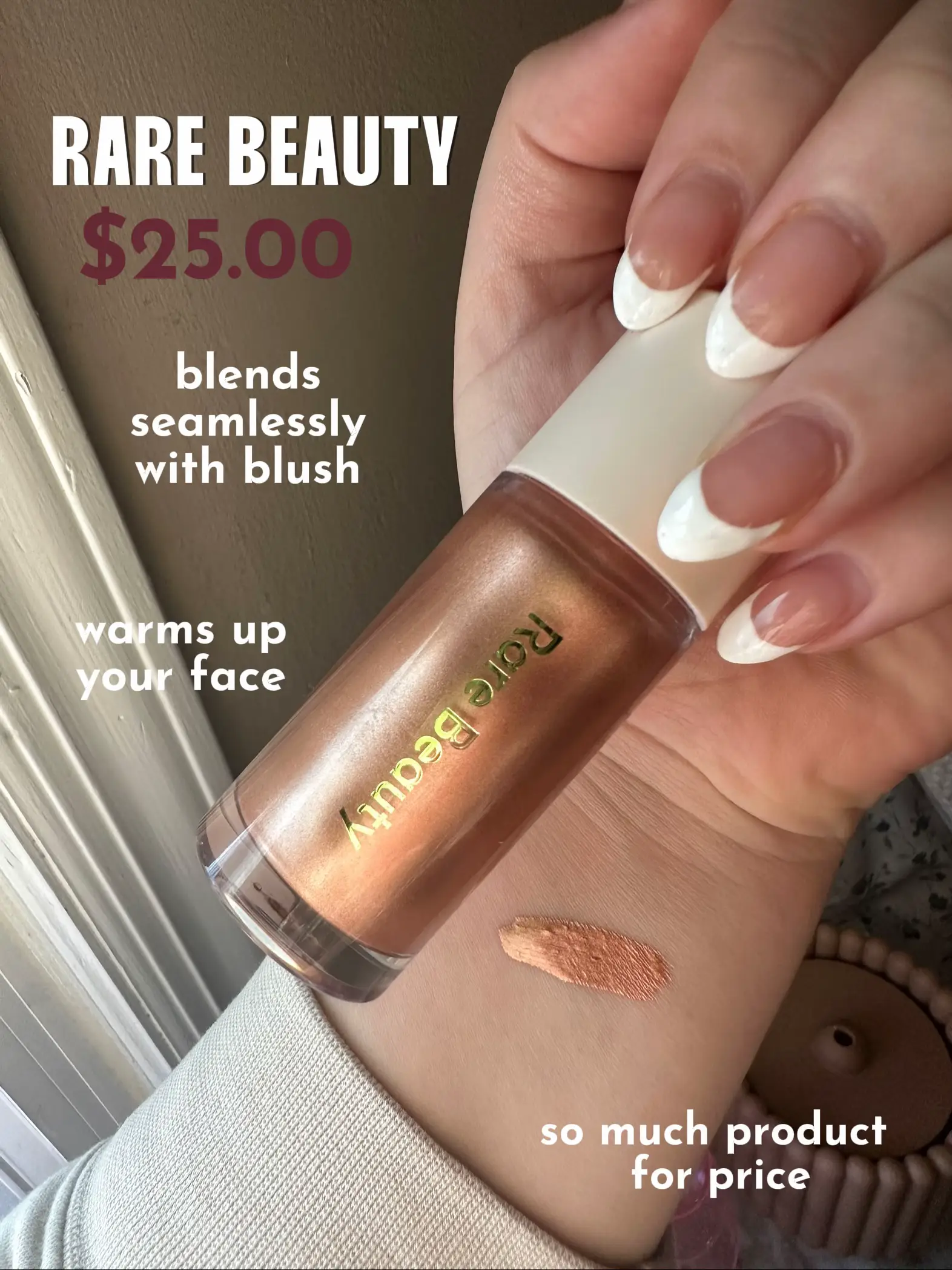  A hand holding a bottle of Rare Beauty blush.